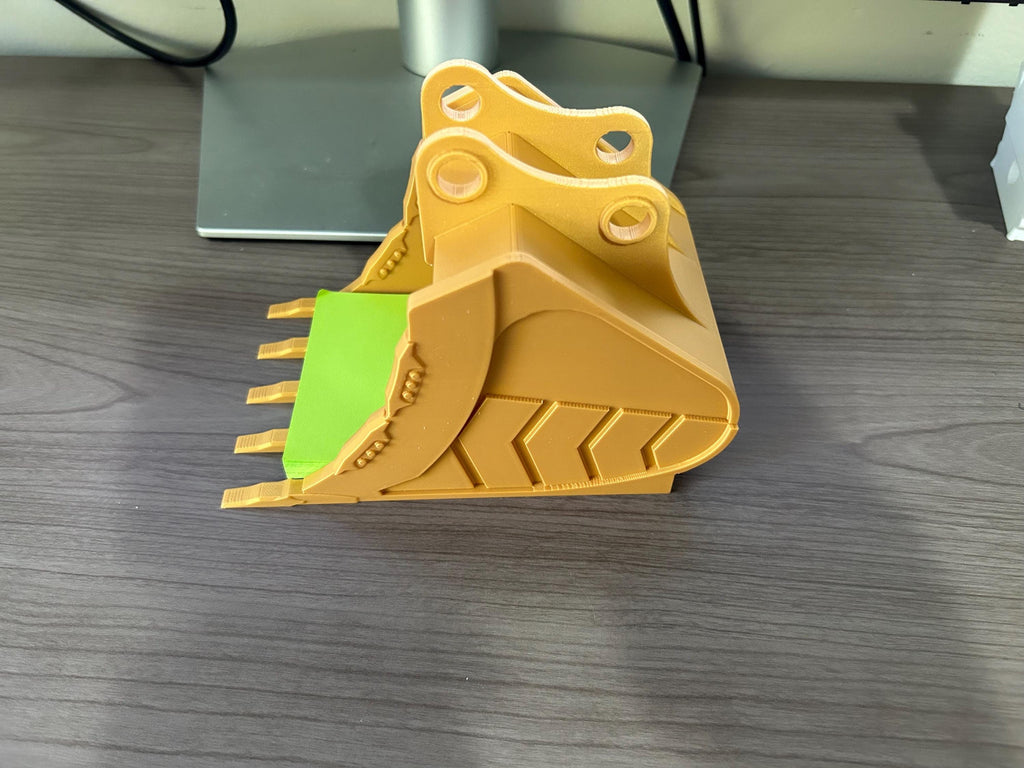 3D printed excavator bucket that holds posted notes